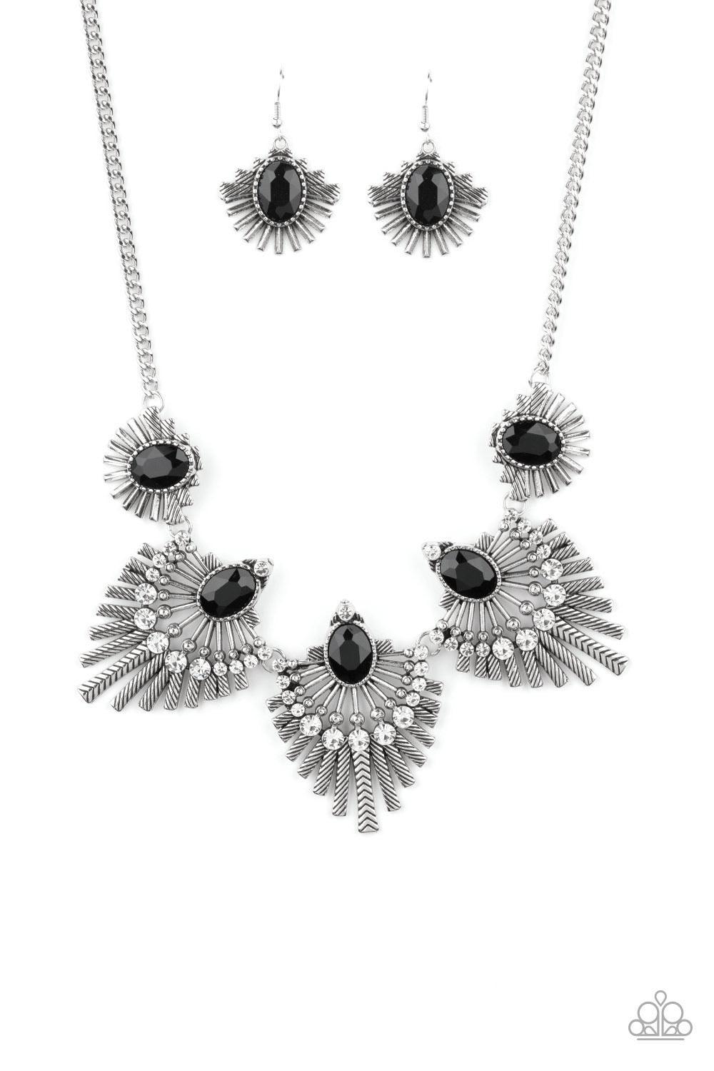 Paparazzi Accessories Miss YOU-niverse - Black Textured metal bars flare out from a mesmerizing black gem, creating a fringe of fanning frames. Sprinkled with white rhinestones, the dazzling display falls just below the collar for a sassy finish. Features