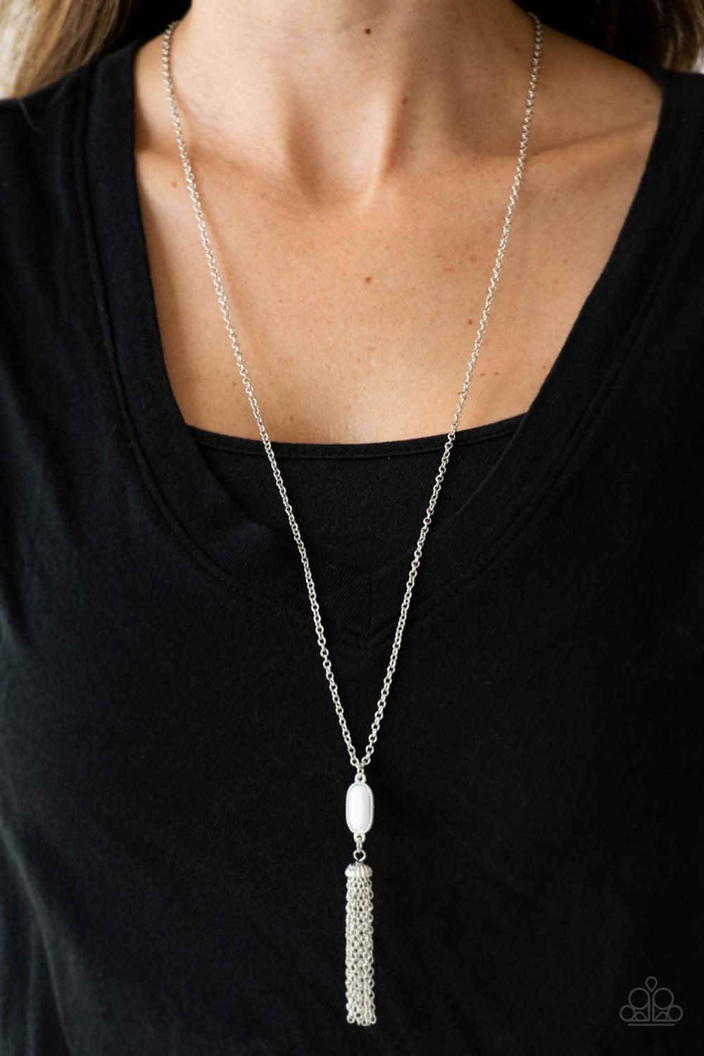 Paparazzi Accessories Tassel Tease - Silver Swinging from a lengthened silver chain, a faceted white bead gives way to a shimmery silver tassel for a whimsical look. Features an adjustable clasp closure. Sold as one individual necklace. Includes one pair