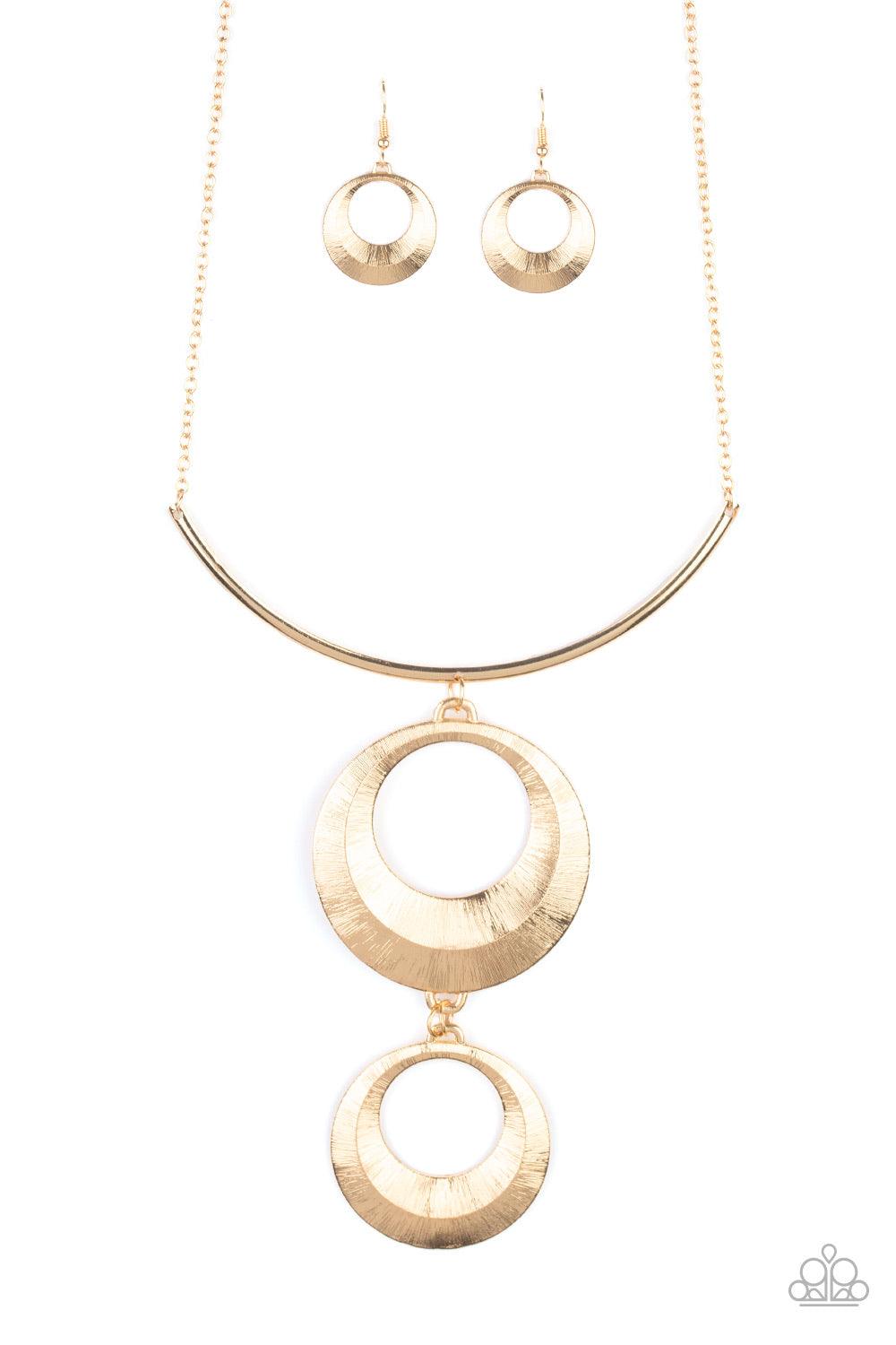 Paparazzi Accessories Egyptian Eclipse - Gold Featuring a blinding scratch finish, two beveled gold circular frames swing from the bottom of a bowing gold rod, creating an edgy stacked pendant down the chest. Features an adjustable clasp closure. Jewelry