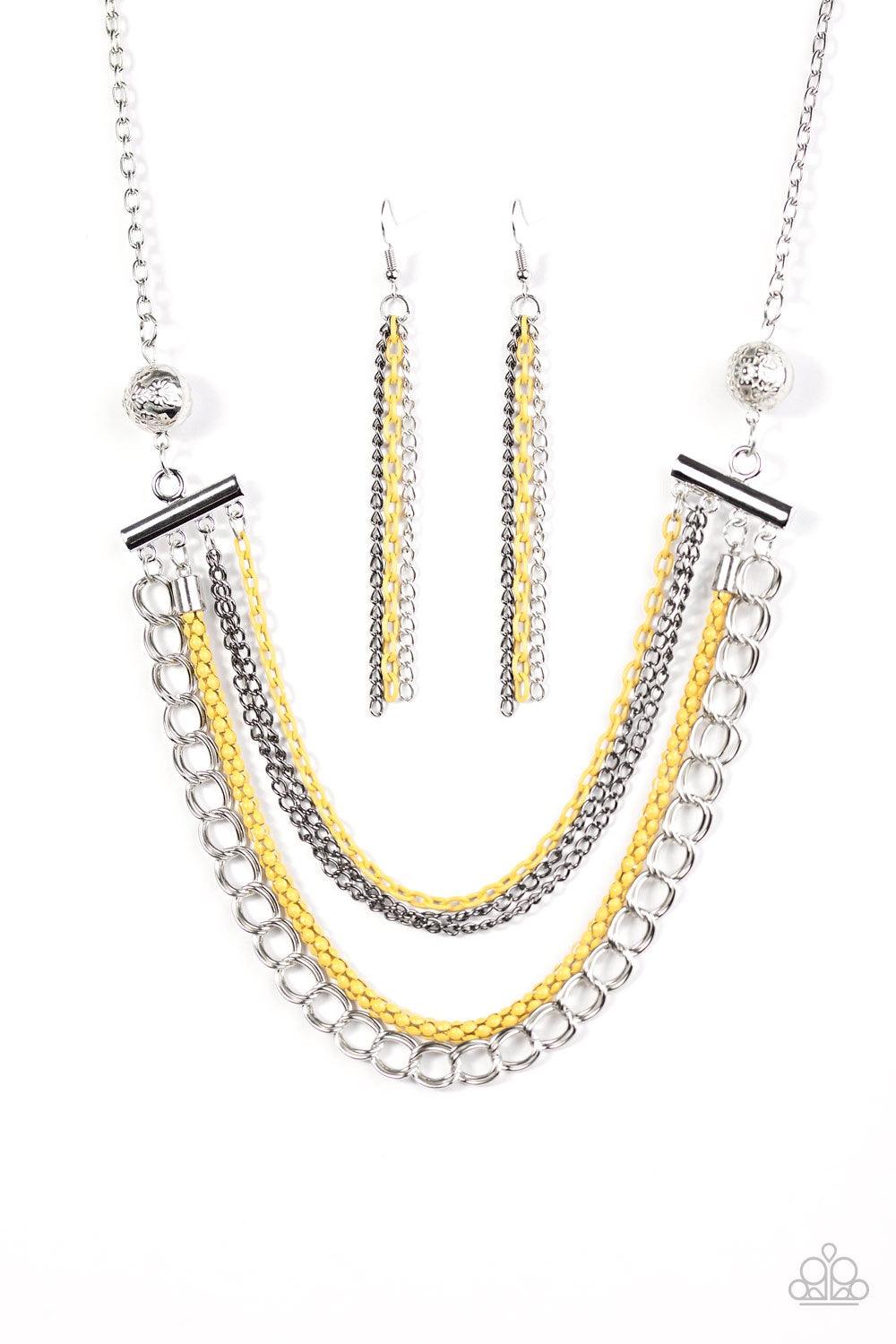 Paparazzi Accessories High-Intensity - Yellow Two floral silver beads give way to an array of yellow, gunmetal, and silver chains. Strung between two metal beads, the mismatched chains layer below the collar in a colorfully industrial fashion. Features an