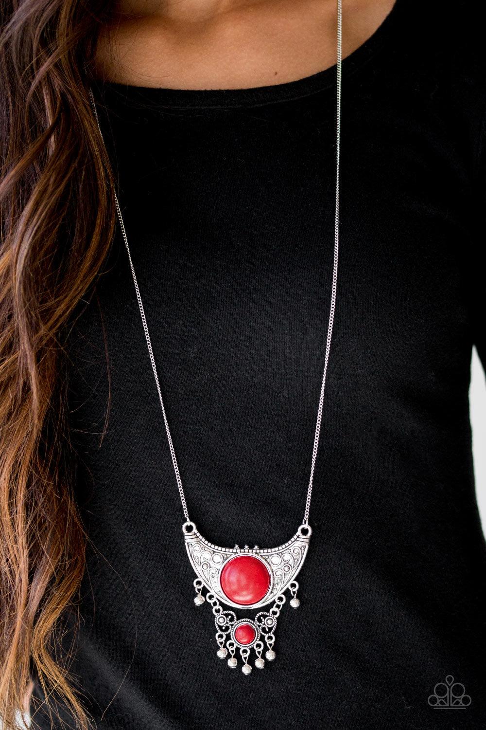 Paparazzi Accessories Summit Style - Red Embossed in dotted and swirling details, a large silver crescent attaches to a smaller frilly frame, creating a stacked pendant. Swinging from the bottom of a lengthened silver chain, the tribal inspired pendant fe