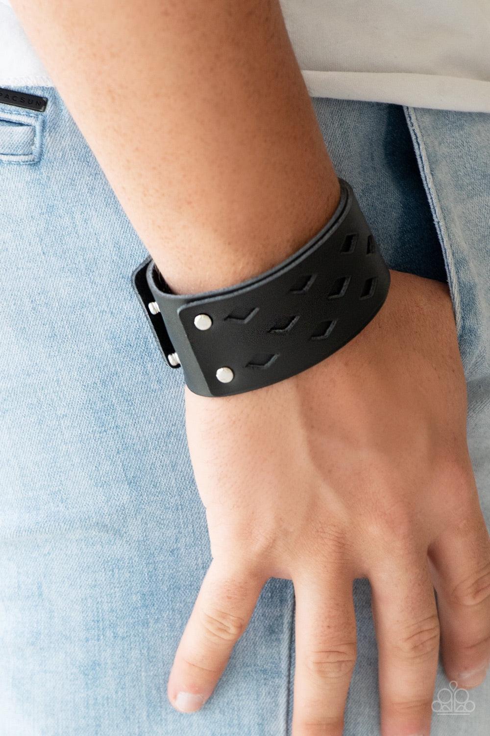 Paparazzi Accessories Bucking Bronco - Black Featuring airy diamond-shape cutouts, a black leather band is studded in place along a thicker black leather band for a rustic look. Features an adjustable snap closure. Jewelry