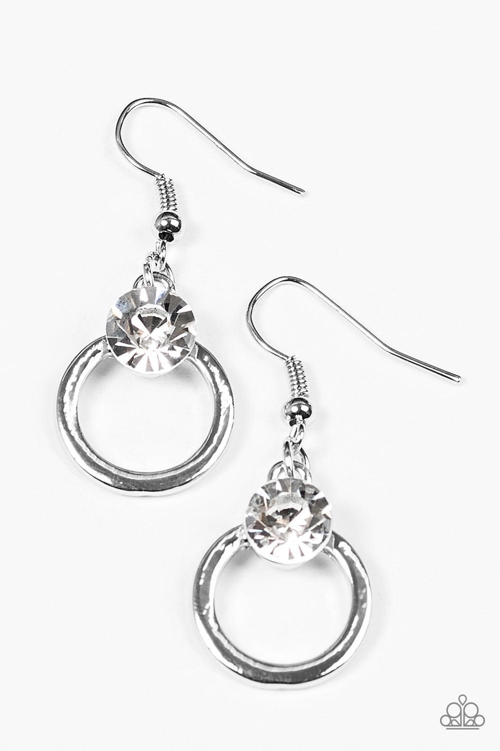 Paparazzi Accessories FAME On - White An oversized white rhinestone crowns the top of a glistening silver hoop for a refined look. Earring attaches to a standard fishhook fitting. Jewelry