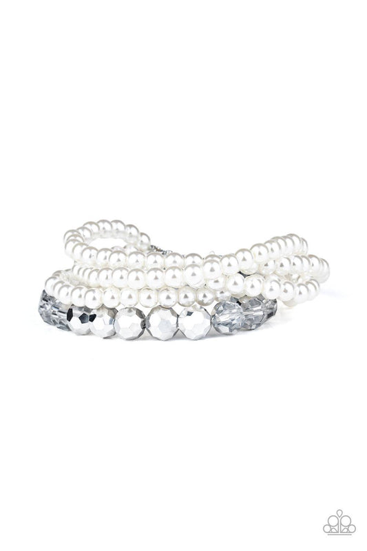 Paparazzi Accessories Refined Renegade - White Strands of classic white pearls and metallic crystal-like beads are threaded along an invisible wire around the wrist, creating refined layers. Features an adjustable clasp closure. Sold as one individual bra