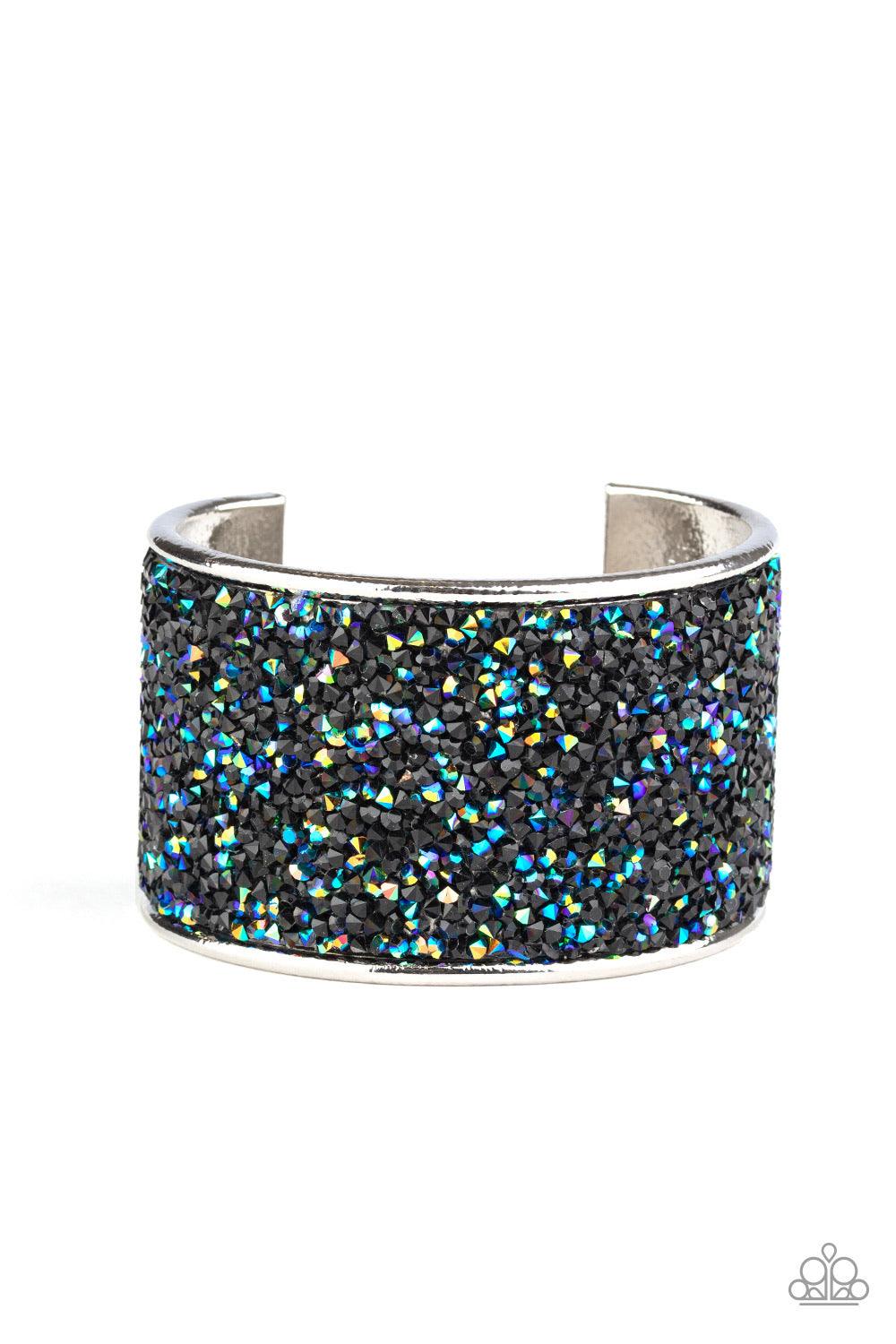 Paparazzi Accessories Stellar Radiance - Black A brilliant collision of glassy black and metallic oil spill rhinestones are encrusted across the front of a thick silver cuff, creating a stellar sparkle. Sold as one individual bracelet. Jewelry