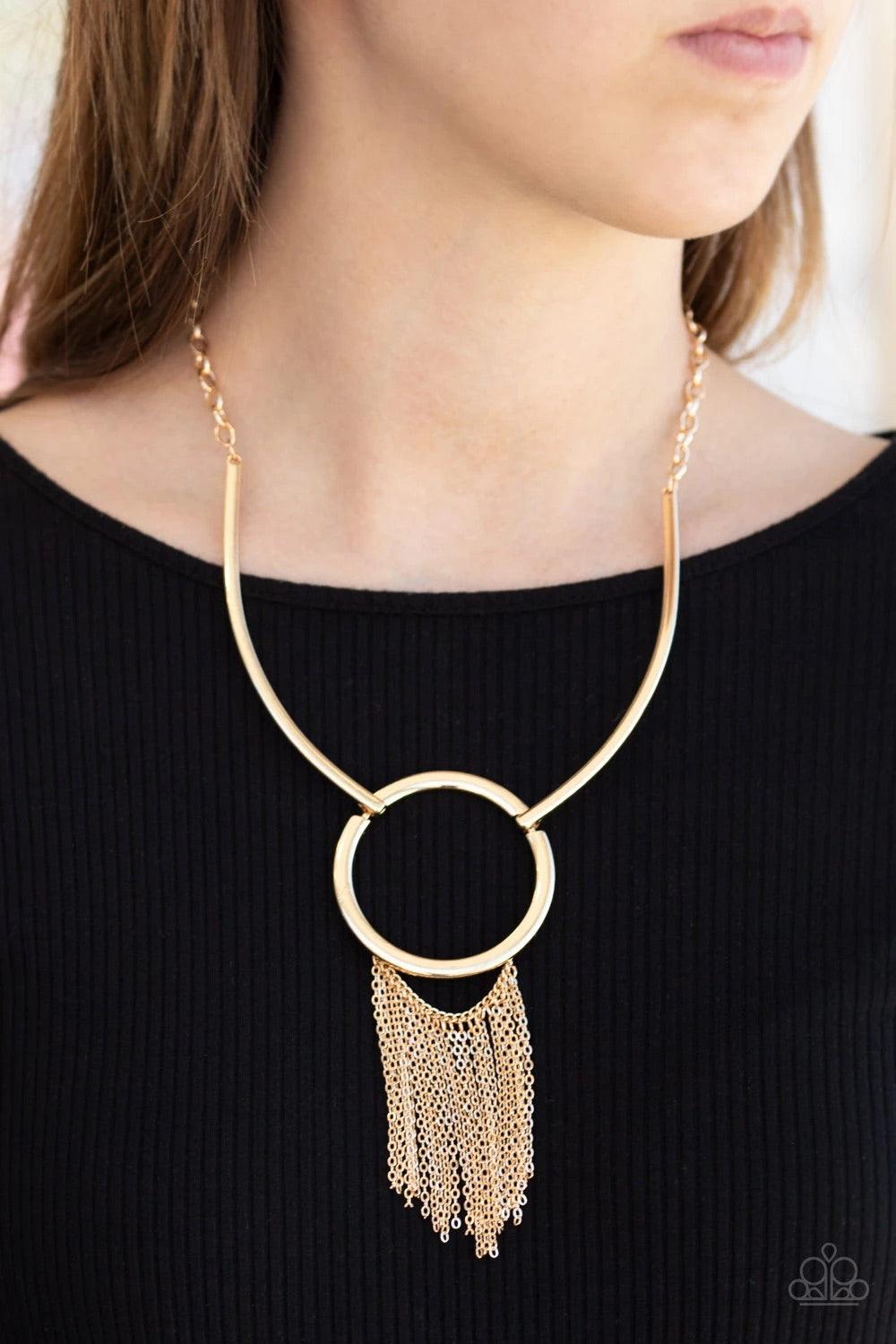 Paparazzi Accessories Pharaoh Paradise - Gold Attached to two bowing gold bars, a shiny gold hoop gives way to a shimmery gold chain fringe, creating a statement making look below the collar. Features an adjustable clasp closure. Sold as one individual ne
