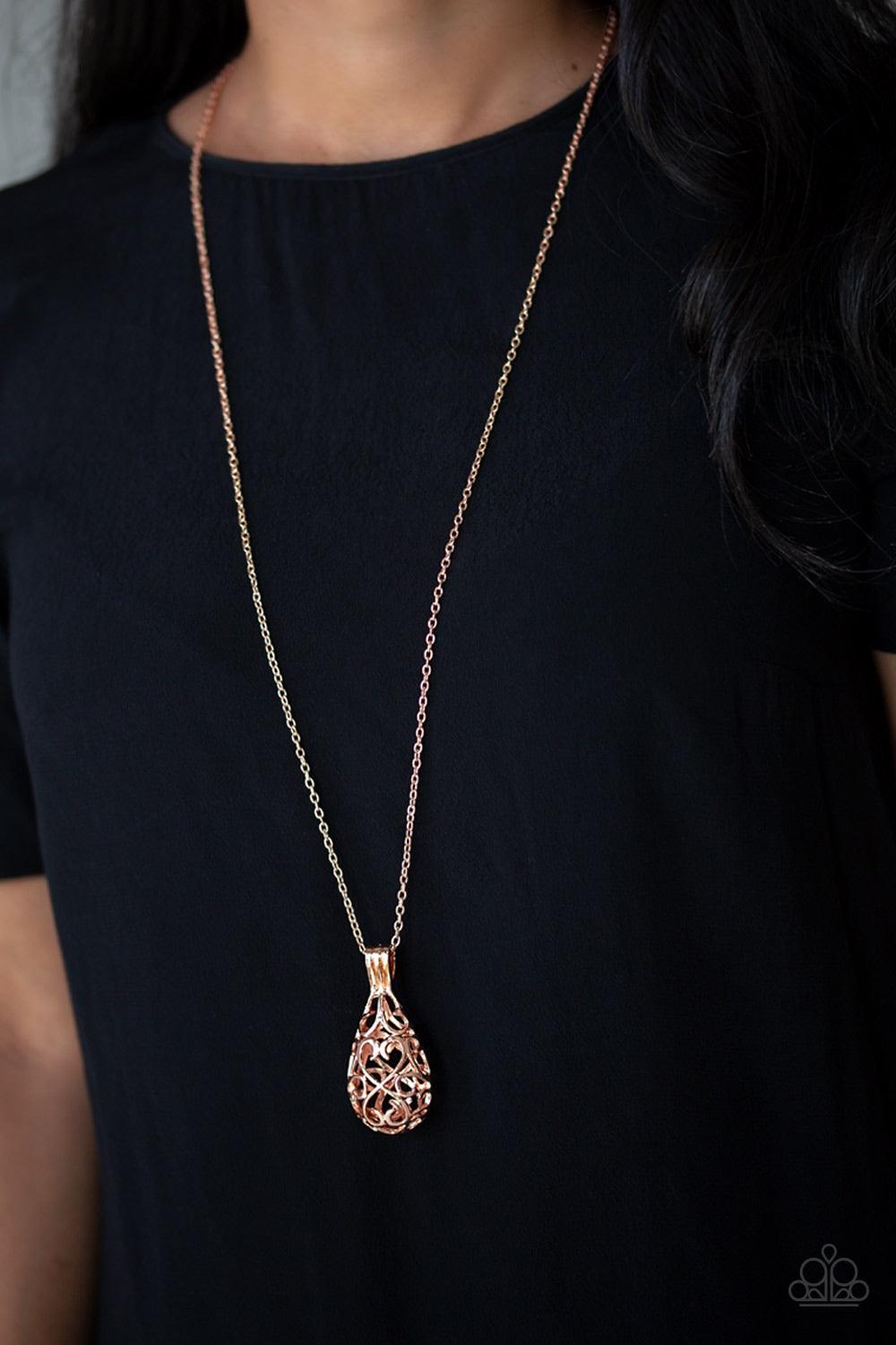 Paparazzi Accessories Magic Potions - Rose Gold Brushed in a high-sheen finish, shimmery rose gold filigree joins into an airy 3-dimensional pendant at the bottom of a lengthened rose gold chain for a whimsical look. Jewelry