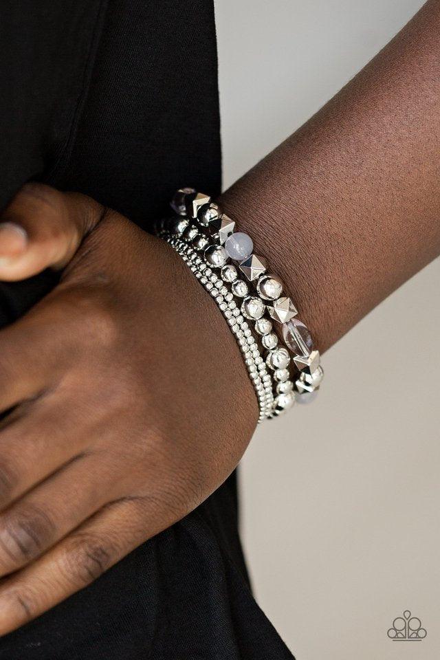Paparazzi Accessories Babe -alicious - Silver Mismatched silver beads and glassy silver beads are threaded along stretchy bands, creating colorful layers across the wrist. Sold as one set of four bracelets. Jewelry