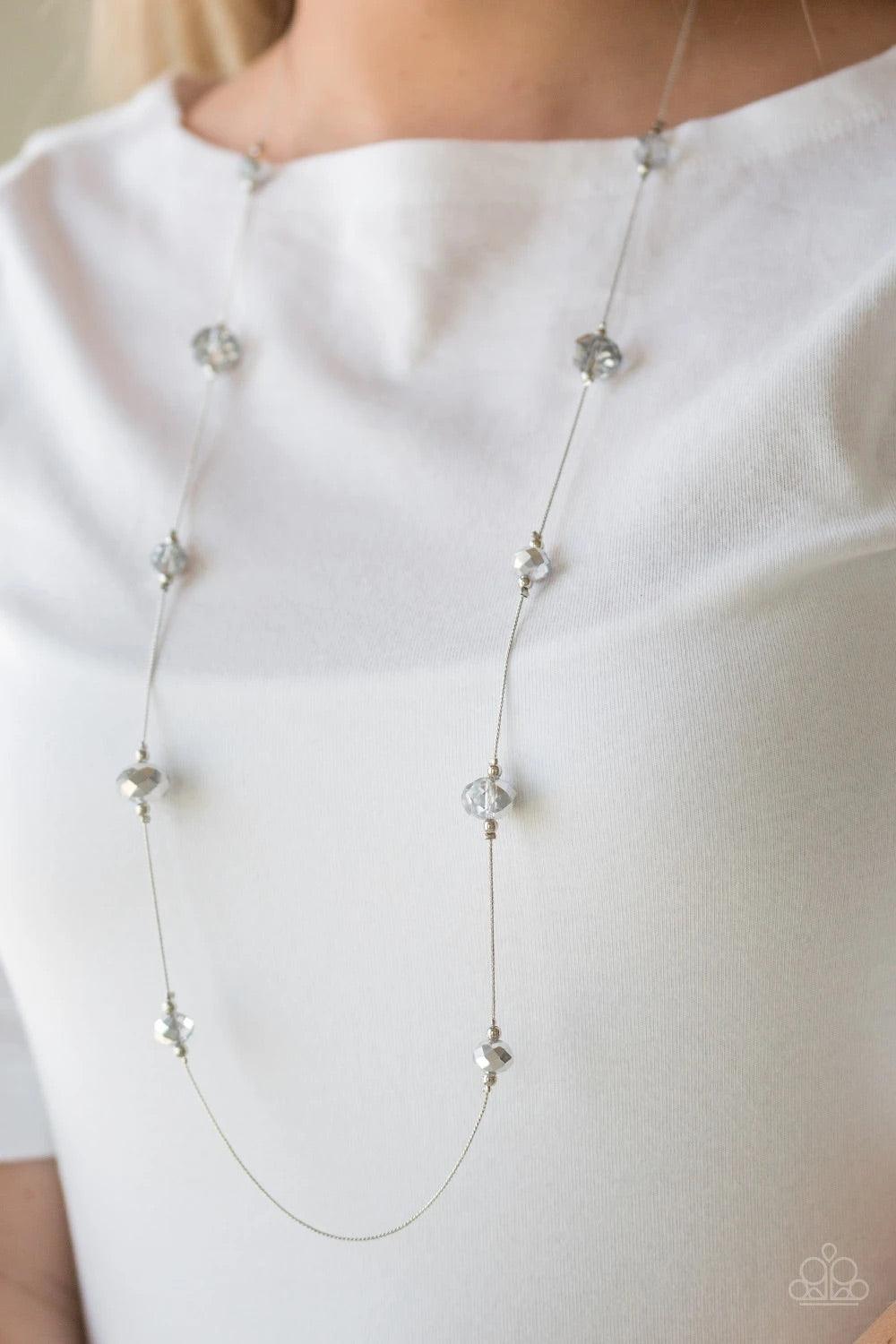 Paparazzi Accessories Champagne On The Rocks - Silver Infused with dainty silver accents, metallic and smoky crystal-like beads trickle along a dainty silver chain across the chest for a refined look. Features an adjustable clasp closure.Sold as one indiv