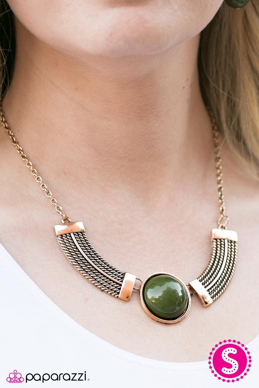 Paparazzi Accessories Egyptian Spell - Green Dramatic gold plates connect with a shiny green circle, creating an indigenous collar-like pendant. Brushed in an antique shimmer, spun ribbons of gold embellish the plates, adding a flashy metallic texture to