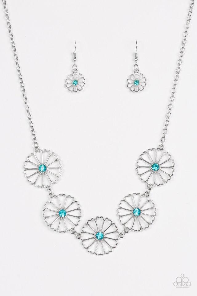 Paparazzi Accessories Daffodil Garden - Blue Stenciled silver floral charms link below the collar. Glittery blue rhinestones dot the floral centers, adding a whimsical finish to the airy palette. Features an adjustable clasp closure. Sold as one individua