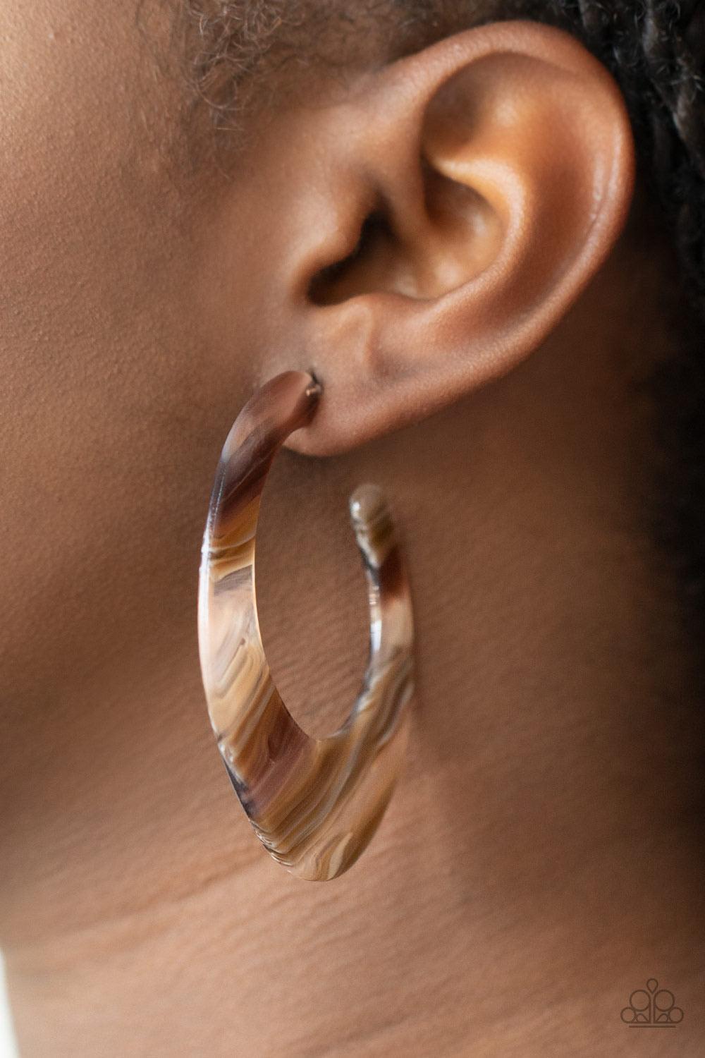 Paparazzi Accessories Retro Renaissance - Brown Lined in brown and white details, a shiny acrylic frame curves into an asymmetrical hoop for a colorfully retro look. Earring attaches to a standard post fitting. Hoop measures approximately 1 1/4" in diamet