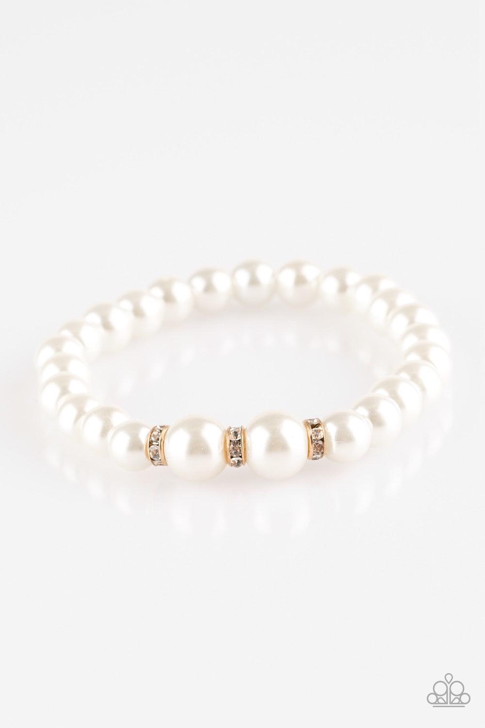 Paparazzi Accessories Radiantly Royal - White Gradually increasing in size near the center, luminescent white pearls are threaded along a stretchy elastic band. White rhinestone encrusted rings are sprinkled along the pearls for a timeless finish. Jewelry