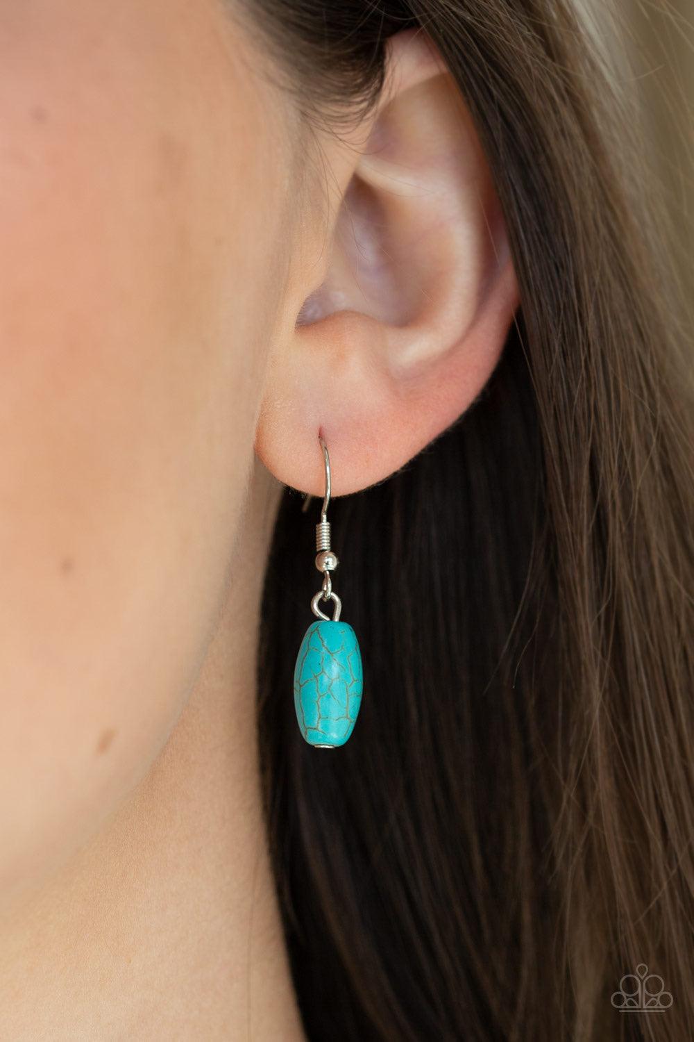 Paparazzi Accessories Explore the Elements - Blue A collection of shiny silver beads and refreshing turquoise stone beads are threaded along an invisible wire below the collar. A dramatically oversized turquoise teardrop pendant swings from the bottom of