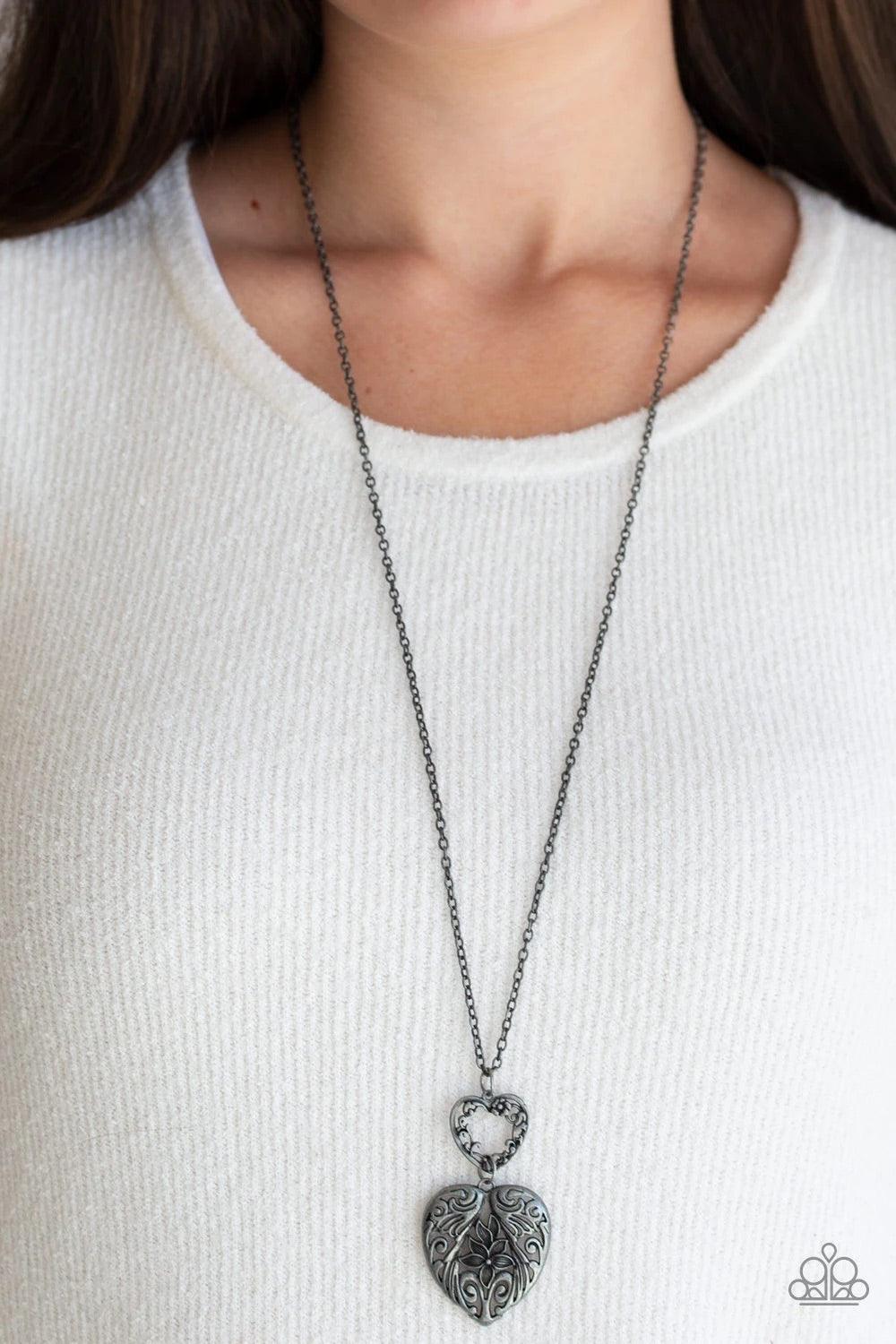Paparazzi Accessories Garden Lovers - Silver Swirling with ornate floral filigree details, a pair of tin finished silver heart frames link at the bottom of a lengthened silver chain for a vintage inspired look. Features an adjustable clasp closure. Sold a