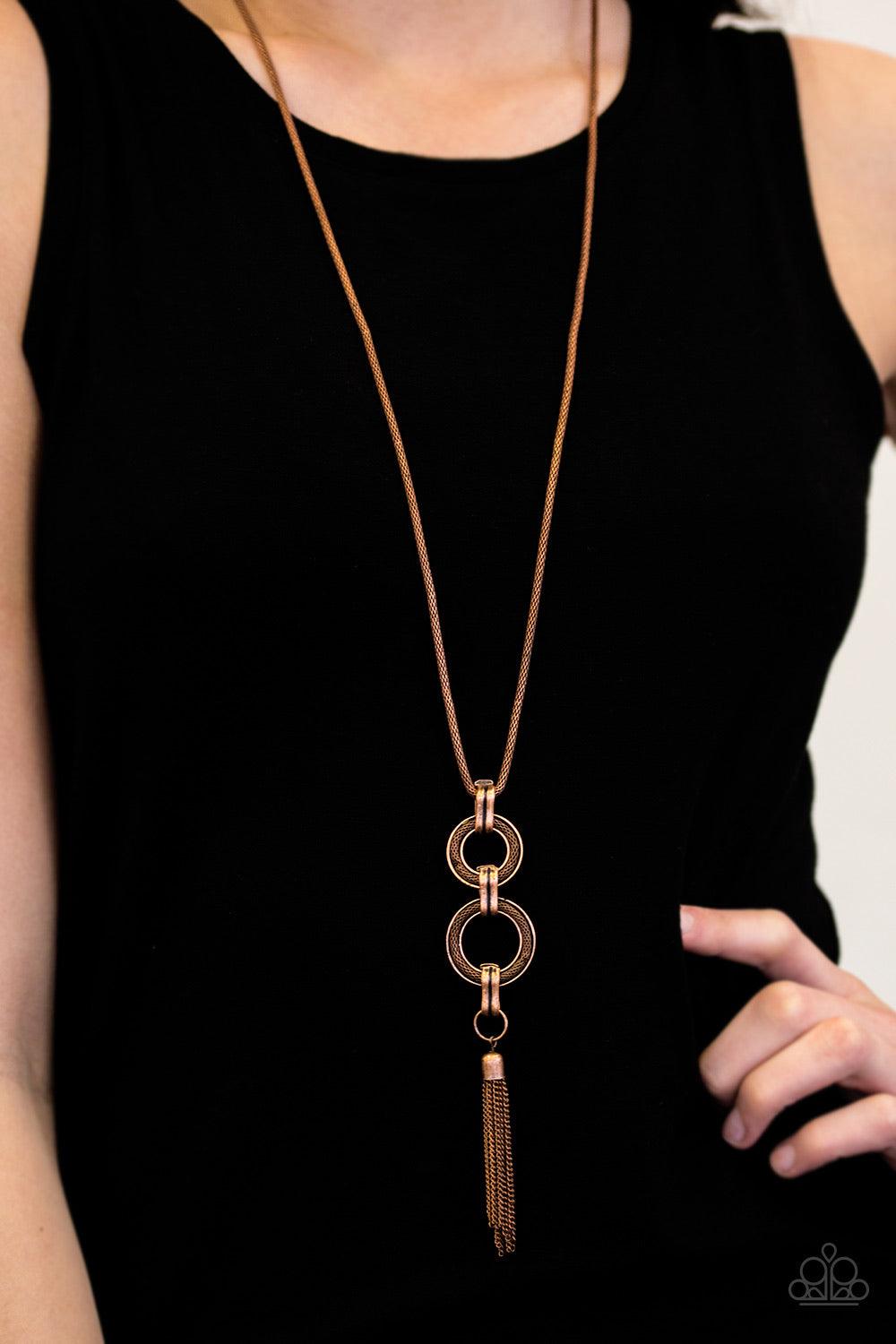 Paparazzi Accessories Full STEAMPUNK Ahead! - Copper A double stacked pendant swings from the bottom of a lengthened mesh chain for a bold industrial look. Infused with a copper tassel, shimmery mesh chain is pressed into the centers of the stacked round