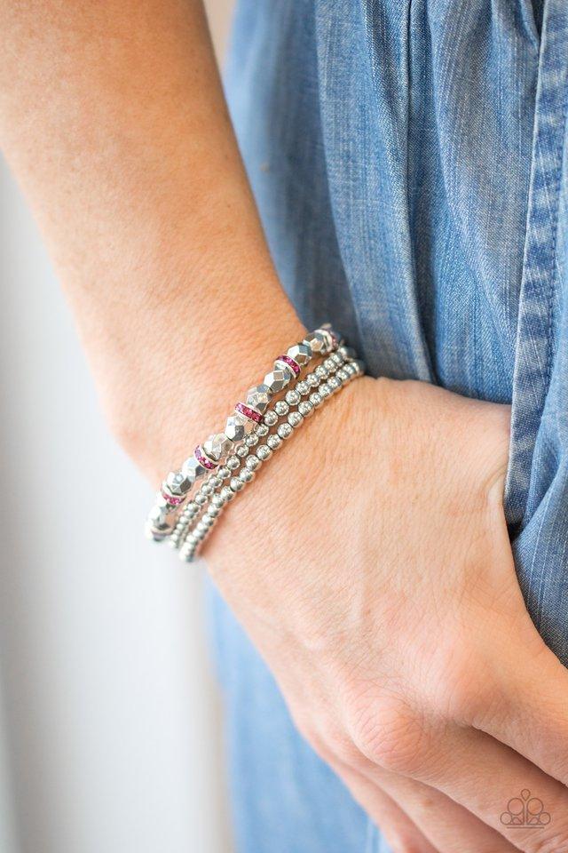Paparazzi Accessories Let There BEAM Light - Pink Infused with pink rhinestone encrusted rings, mismatched dainty silver and faceted silver beads are threaded along stretchy bands for a refined look. Shiny and pink you cant go wrong with this adorable sta