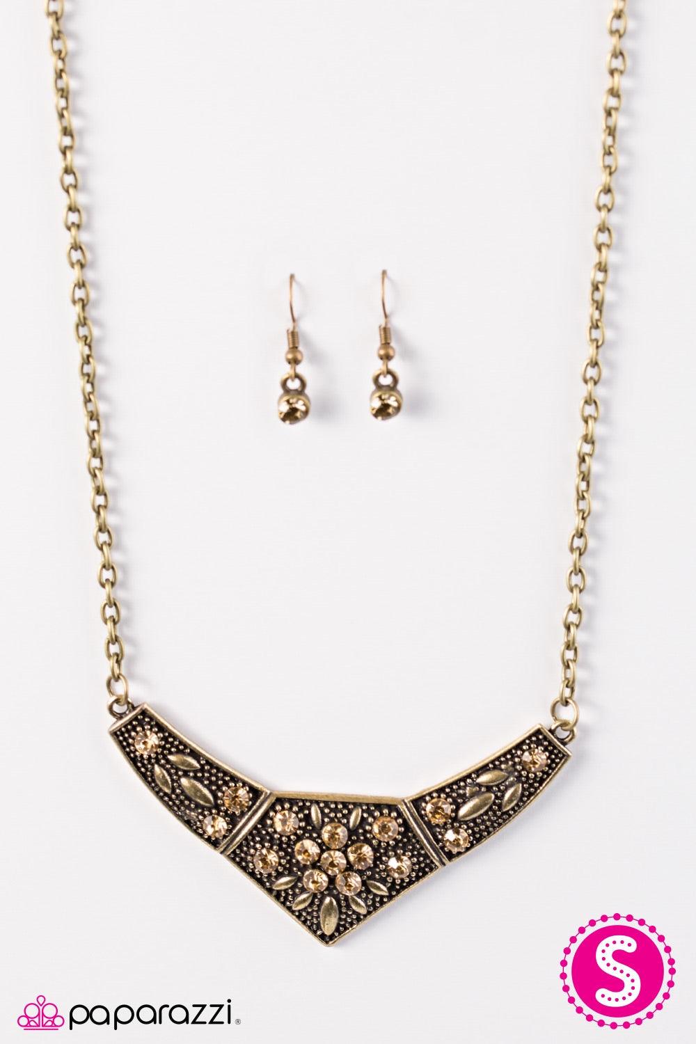 Paparazzi Accessories Born to Shimmer - Brass Embossed in leafy patterns, a bold brass frame falls below the collar in dramatic fashion. Golden topaz rhinestones are sprinkled across the frame, creating a feminine floral center. Features an adjustable cla
