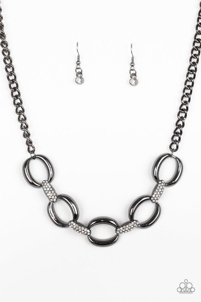 Paparazzi Accessories Boss Boulevard - Black Bold gunmetal links join with white rhinestone encrusted frames below the collar for a fierce look. Features an adjustable clasp closure. Sold as one individual necklace. Includes one pair of matching earrings.