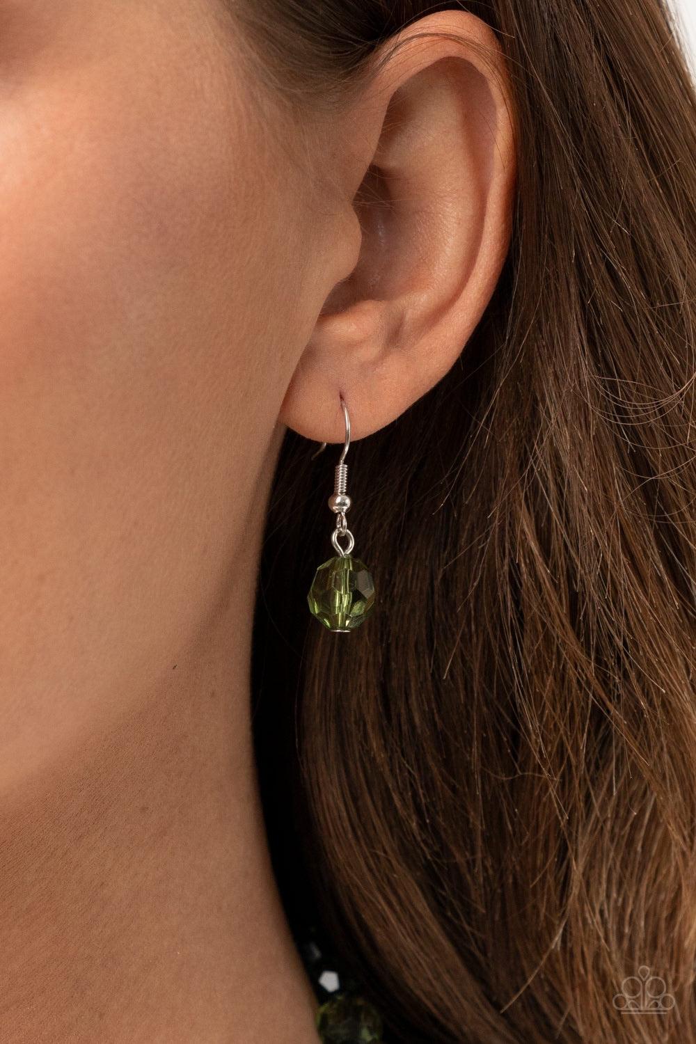 Paparazzi Accessories Malibu Masterpiece - Green Varying in shape and size, glassy green beads are knotted in place along shiny black cording, creating a dazzling display across the chest. Features an adjustable clasp closure. Sold as one individual neckl
