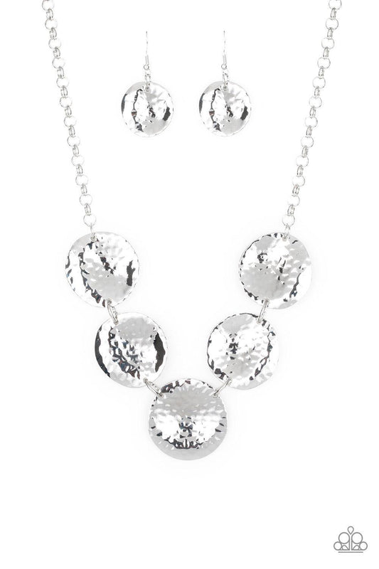 Paparazzi Accessories First Impressions - Silver Featuring a hammered high-sheen finish, imperfect round silver frames link below the collar for a casual look. Features an adjustable clasp closure. Sold as one individual necklace. Includes one pair of mat