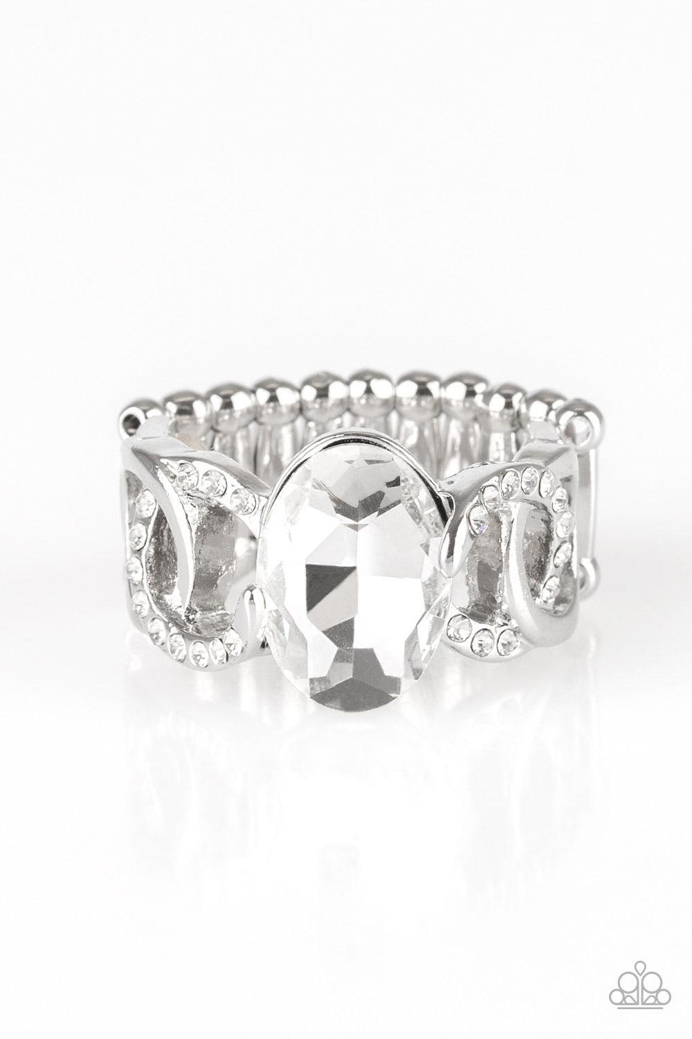 Paparazzi Accessories Supreme Bling - White White rhinestone encrusted frames and shiny silver frames link across the finger, coalescing into an airy band. A glittery white rhinestone is pressed into the center of the band for a glamorous finish. Features