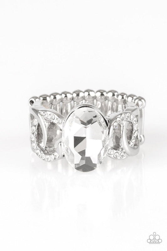 Paparazzi Accessories Supreme Bling - White White rhinestone encrusted frames and shiny silver frames link across the finger, coalescing into an airy band. A glittery white rhinestone is pressed into the center of the band for a glamorous finish. Features