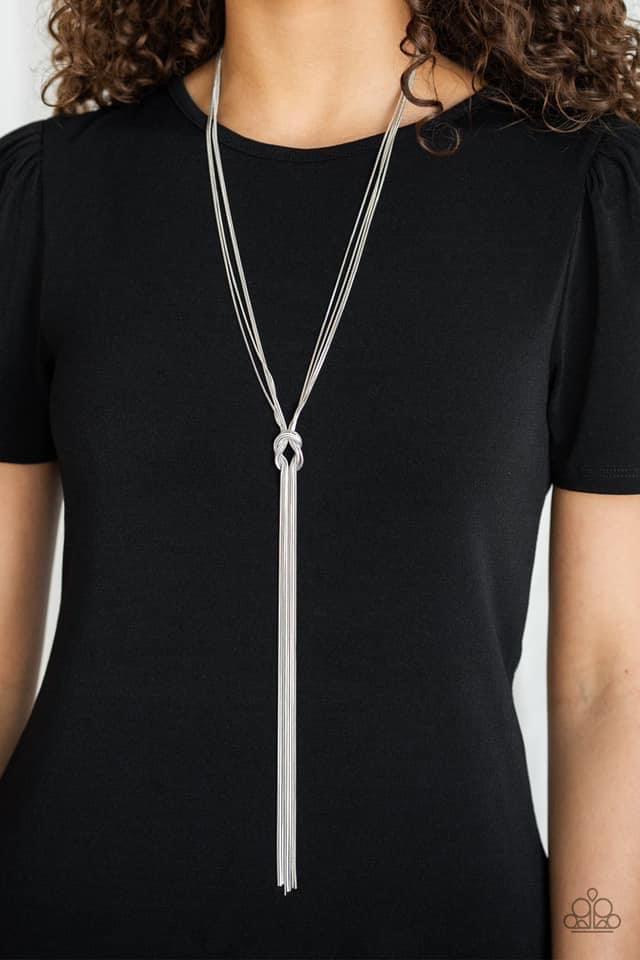 Paparazzi Accessories Forget Me Knot - Silver Dainty strands of glistening silver snake chain delicately knot into a timeless tassel for a refined flair. Features an adjustable clasp closure. Sold as one individual necklace. Includes one pair of matching
