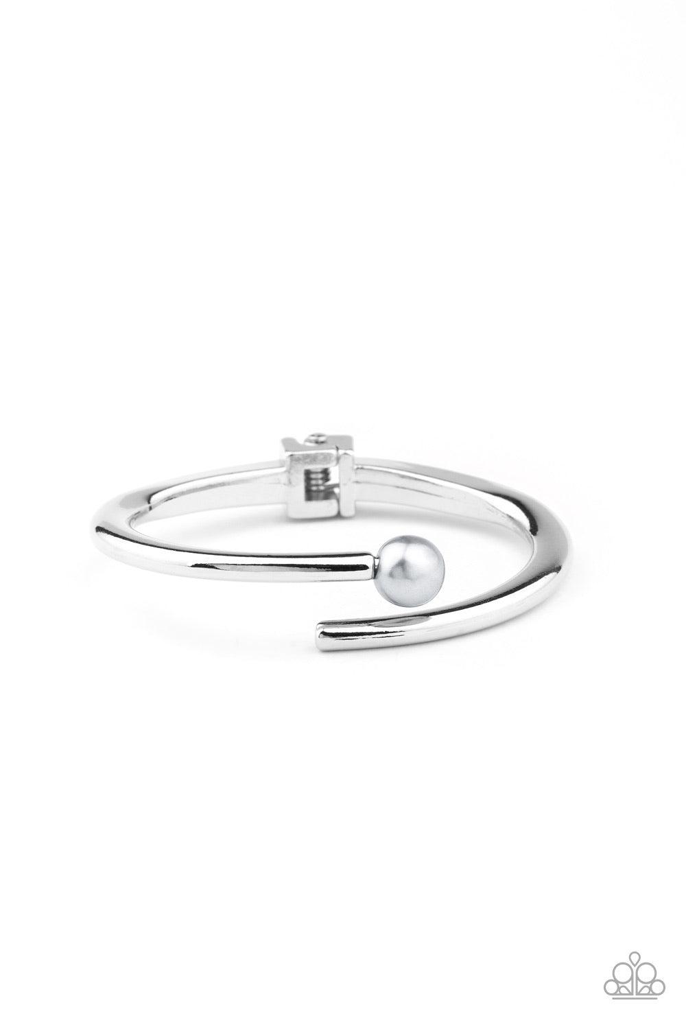 Paparazzi Accessories Industrial Impact - Silver Featuring a solitaire silver pearl, two shiny silver bars attach to a spring-like fitting as they curl around the wrist for a modern finish. Jewelry