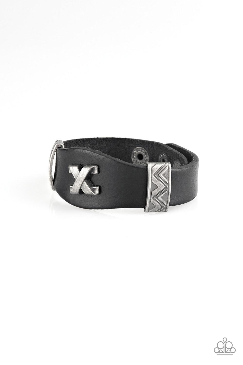 Paparazzi Accessories Tread Carey - Black Featuring ornate metallic accents, an antiqued crisscross frame embellishes the center of a black leather band for an edgy urban look. Features an adjustable snap closure. Jewelry
