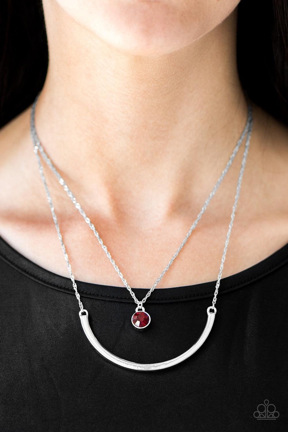 Paparazzi Accessories Moonlit Metro - Red A red gem swings from the uppermost chain above a bowing silver bar. The shimmery layers flawlessly drape below the collar in a refined fashion. Features an adjustable clasp closure. Jewelry