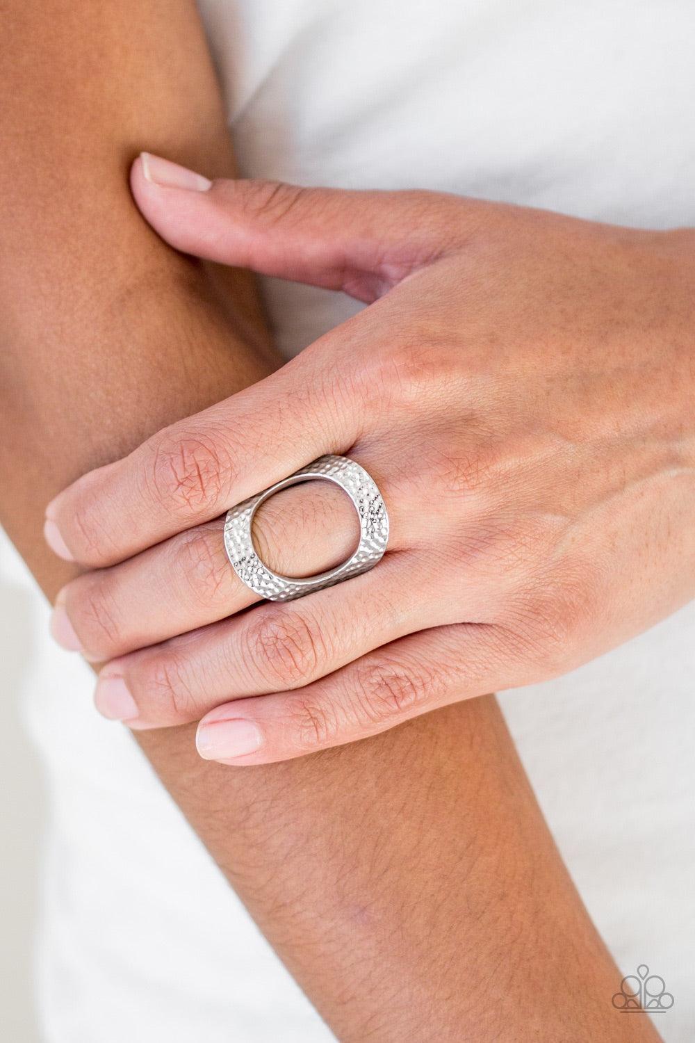 Paparazzi Accessories Tour De Contour - Silver Delicately hammered in shimmery textures, a glistening silver frame circles atop the finger for a modern look. Features a stretchy band for a flexible fit. Jewelry