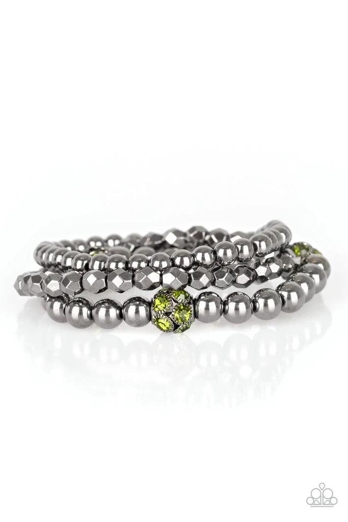 Paparazzi Accessories Noticeably Noir - Green Mismatched gunmetal beads and green rhinestone encrusted beads are threaded along stretchy bands for an edgy and refined look. Sold as one set of three bracelets. Bracelets