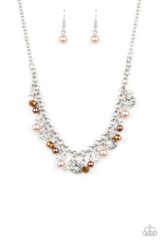 Paparazzi Accessories Coastal Cache - Mutli Pearly white and brown beads, aurum crystal-like gems, and hammered silver discs swing from a bold silver chain, creating a refined fringe below the collar. Features an adjustable clasp closure. Sold as one indi