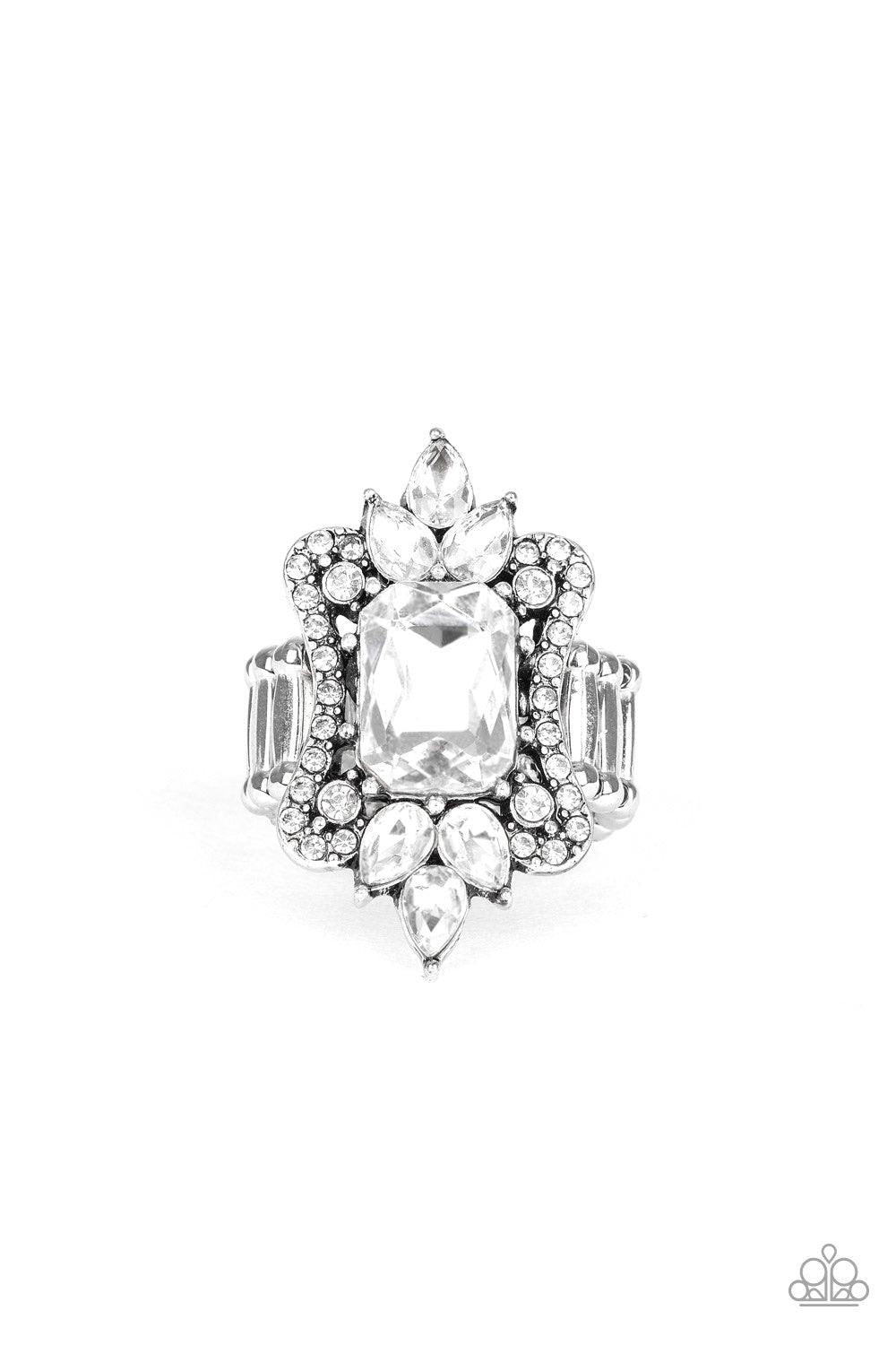 Paparazzi Accessories Things That Go Boom - White A blinding collection of round and teardrop white rhinestones coalesce around an oversized emerald-style gem, creating a dramatic statement piece atop the finger. Features a stretchy band for a flexible fi