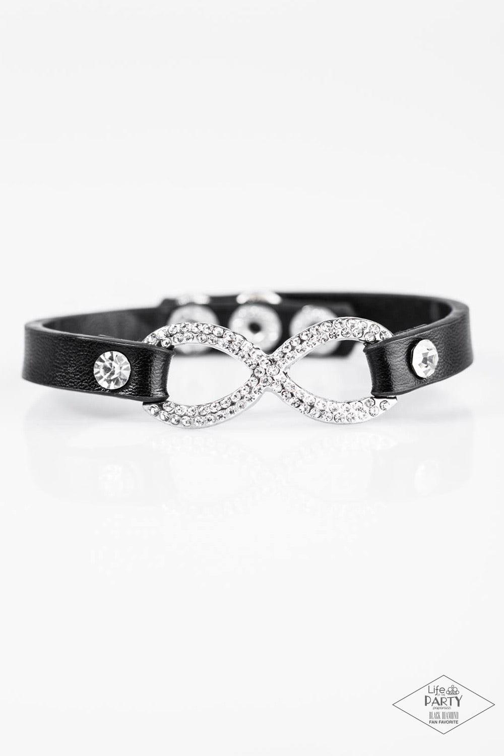 Paparazzi Accessories Innocent Till Proven Guilty - White A skinny strip of black leather attaches to a silver infinity symbol encrusted in glittery rhinestones. Flanked by two dazzling solitaire rhinestones, the glitzy design creates an incandescent cent