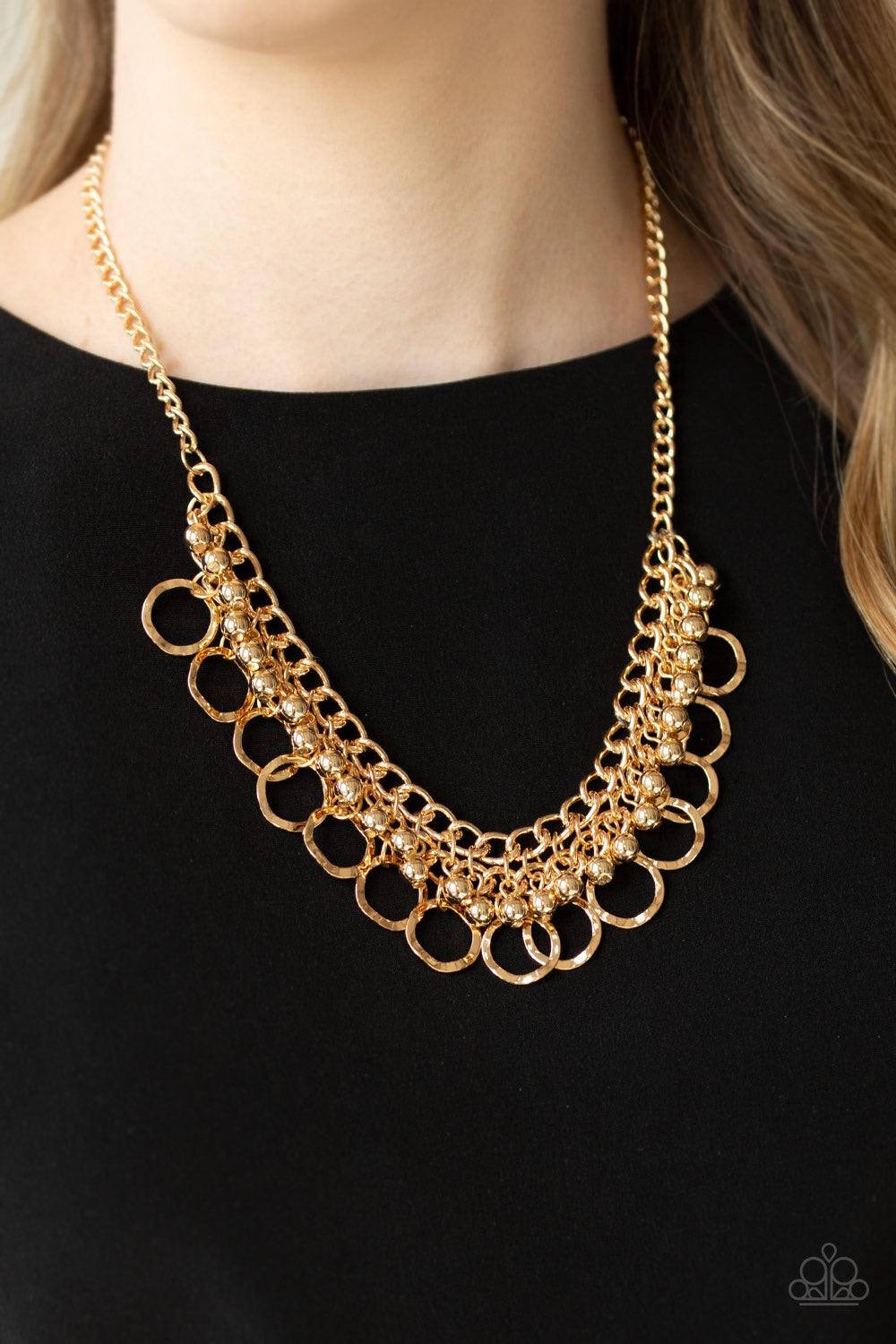 Paparazzi Accessories Ring Leader Radiance - Gold Rows of shiny gold beads and hammered gold rings swing from the bottom of interlocking gold chains, creating a bold fringe below the collar. Features an adjustable clasp closure. Jewelry