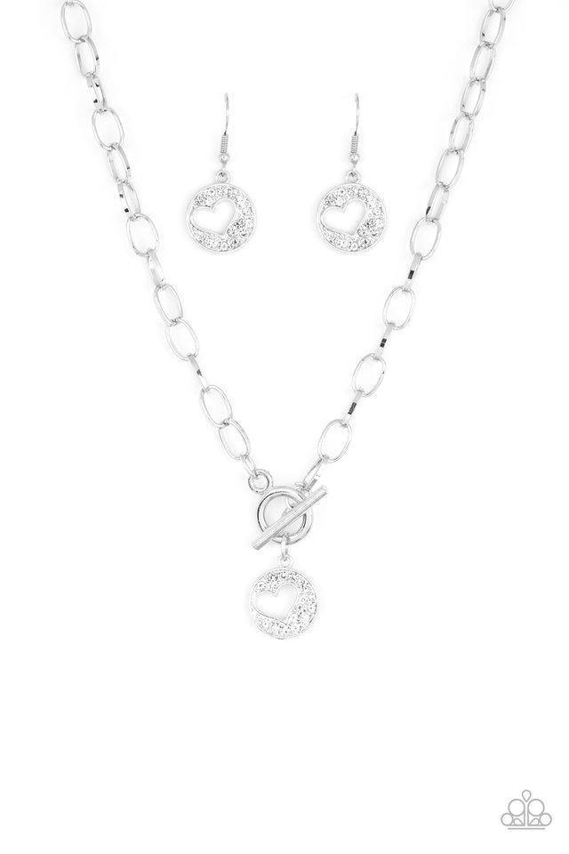 Paparazzi Accessories Heartbeat Retreat - White Radiating with glittery white rhinestones, an airy heart pendant swings from the bottom of a glistening silver chain below the collar for a flirty flair. Features a toggle clasp. Sold as one individual neckl