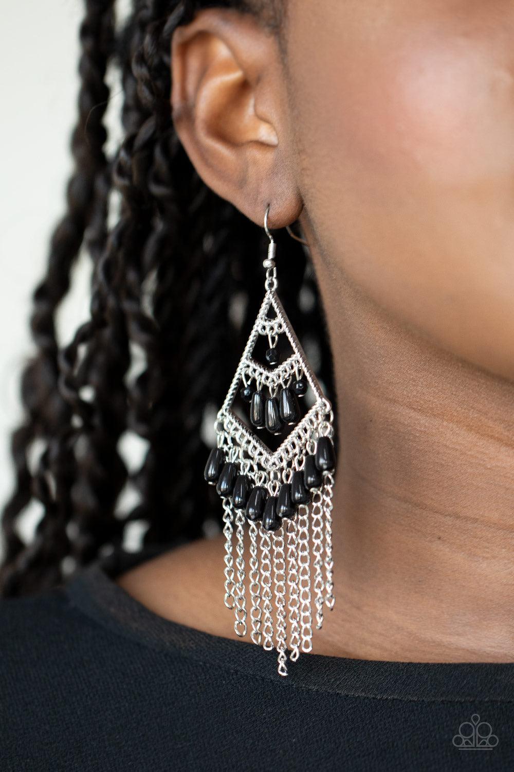 Paparazzi Accessories Trending Transcendence - Black Dainty black teardrop beads cascade from three tiers of a silver kite-shaped frame. Shimmery silver chains stream from the bottom of the frame, adding movement to the colorful fringe. Earring attaches t