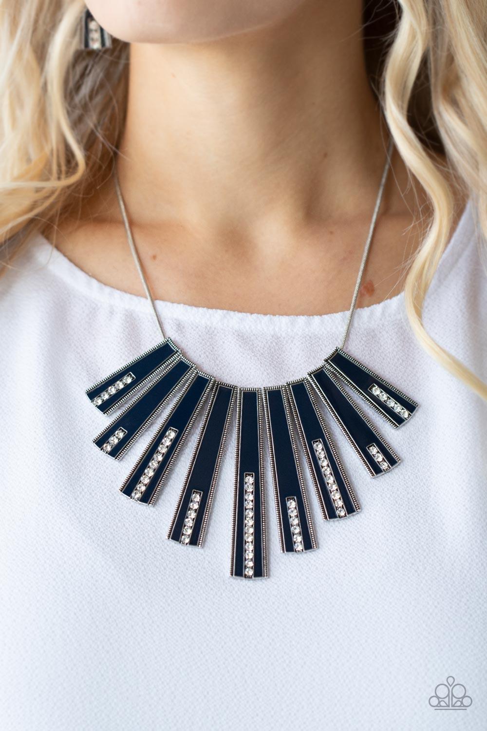 Paparazzi Accessories FAN-tastically Deco - Blue Encased in daintily dotted silver frames, a row of flared silver bars painted in a glossy Navy Blue fans out across the collar. A column of sparkling white rhinestones rises from the bottom of each frame, c