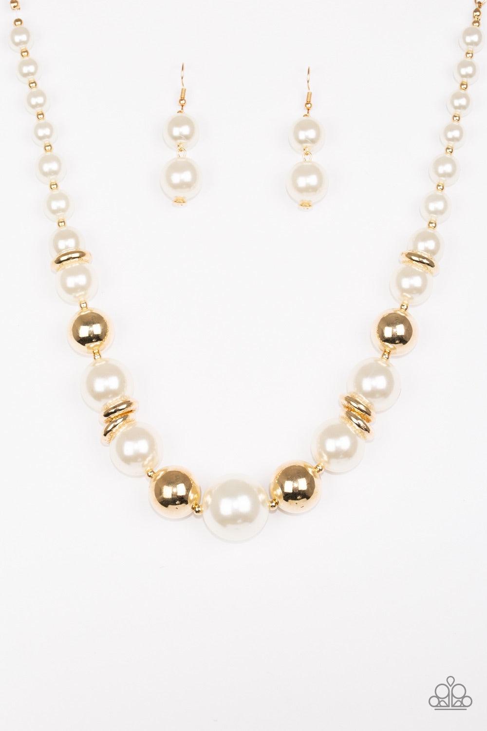 Paparazzi Accessories New York Nightlife - Gold Gradually increasing in size toward the center, dramatic white pearls and shiny gold beads drape below the collar for a refined look. Glistening gold accents are sprinkled between the classic beads, adding d