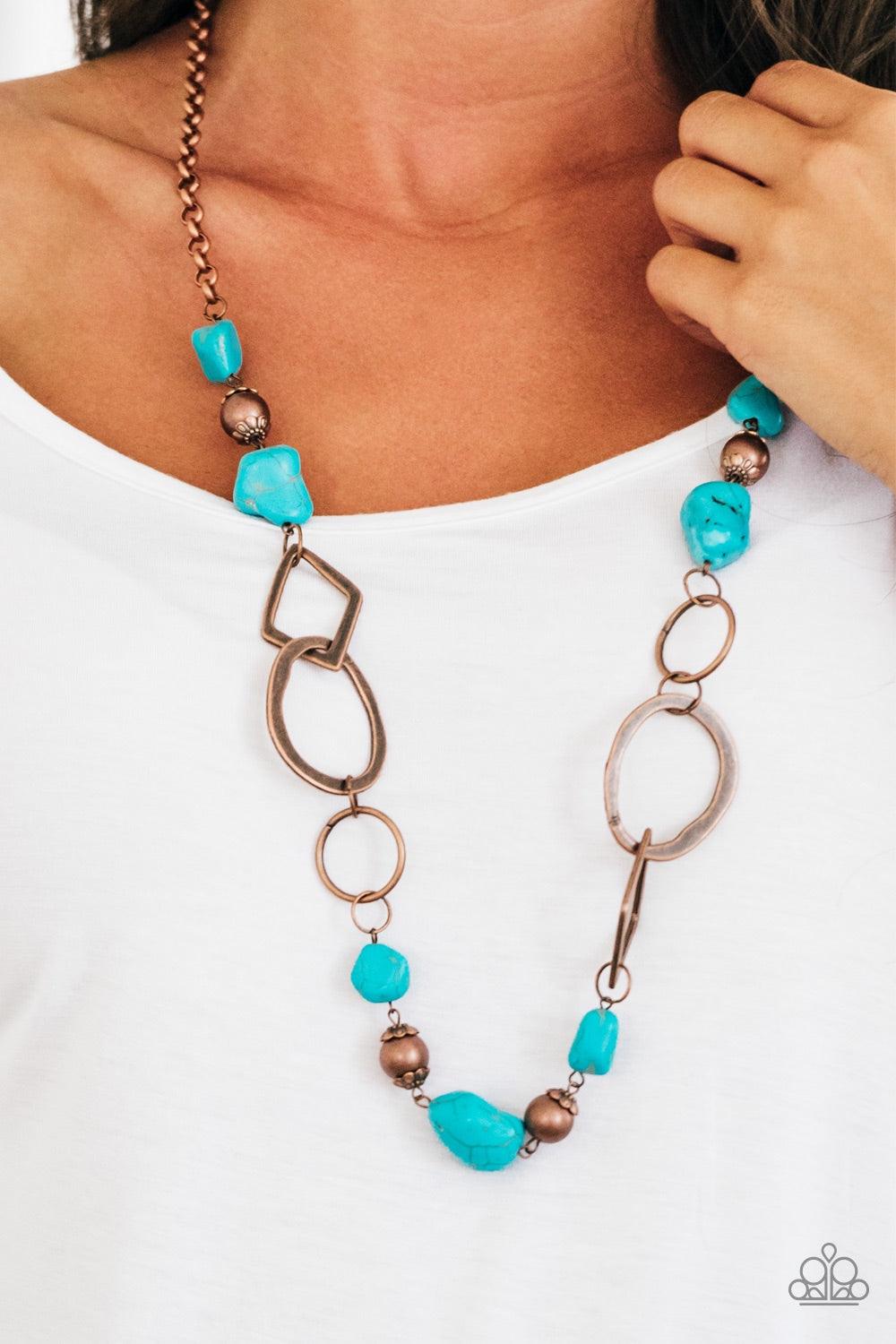 Paparazzi Accessories That’s TERRA-I ficic! - Copper Bits of refreshing turquoise stones and ornate copper beading give way to asymmetrical copper frames. The mismatched frames drape across the chest, creating an earthy collision of rock and metal. Featur