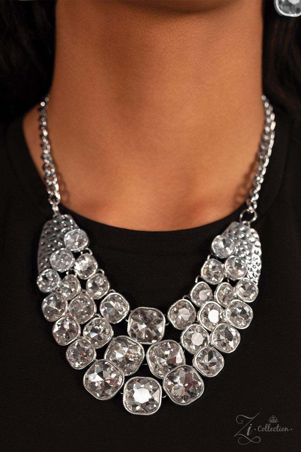 Paparazzi Accessories Unstoppable Two delicately hammered silver fittings give way to three rows of sparkling white rhinestones, each encased in a sleek silver frame. The subtly rounded edges of each glittery gem add a touch of femininity to the bold desi