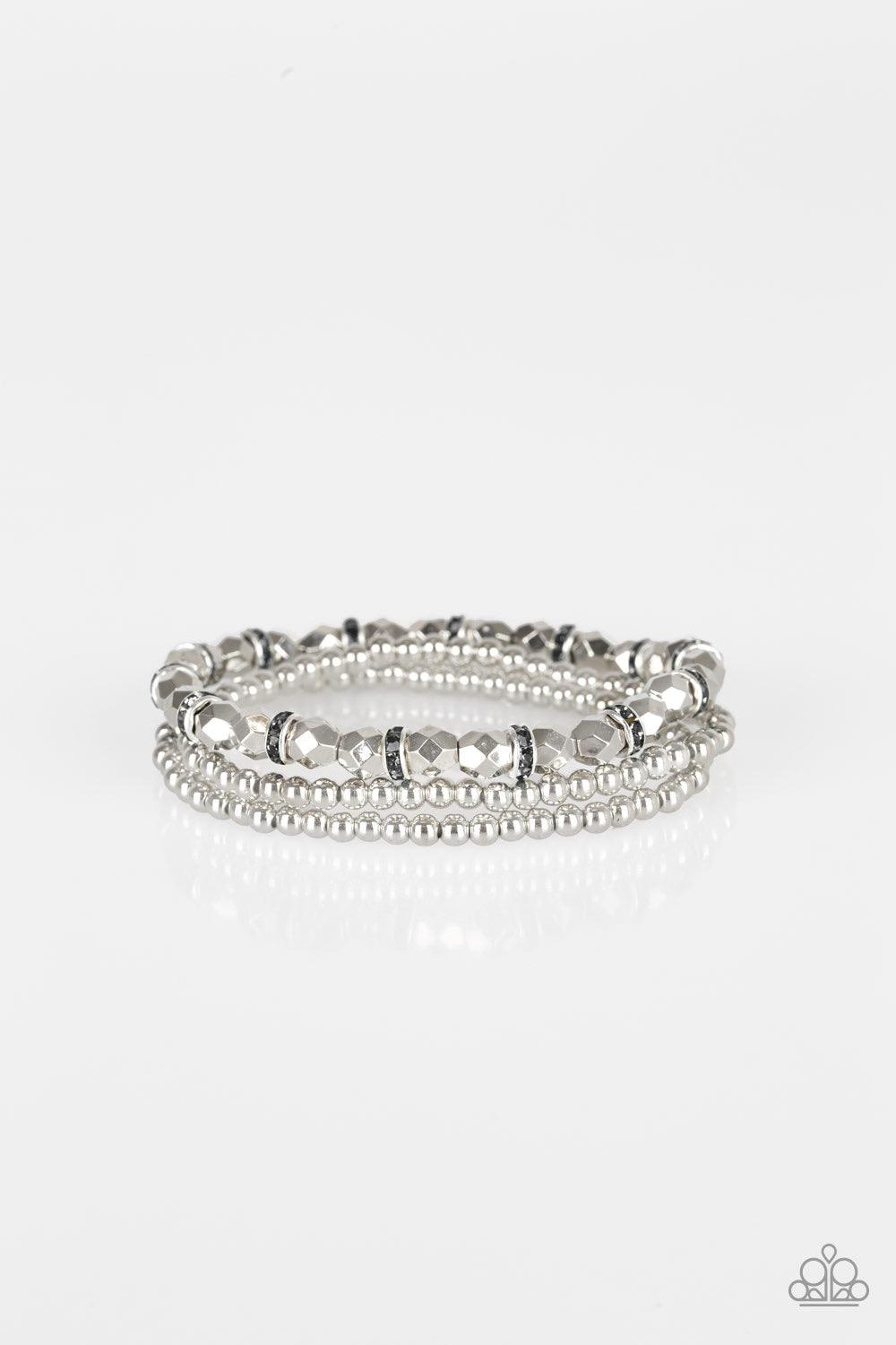 Paparazzi Accessories Let There BEAM Light - Silver Infused with hematite rhinestone encrusted rings, mismatched dainty silver and faceted silver beads are threaded along stretchy bands for a refined look. Sold as one set of three bracelets. Jewelry