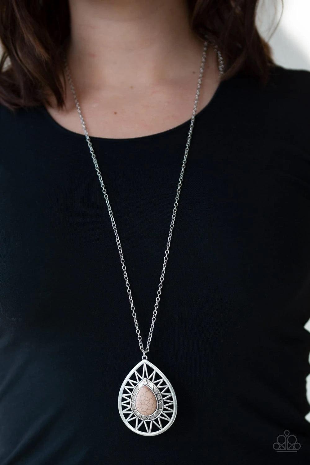 Paparazzi Accessories Summer Sunbeam - Brown An earthy brown stone is pressed into the center of a large silver teardrop radiating with shimmery sunburst patterns. The tribal inspired pendant swings from the bottom of a lengthened silver chain for a drama