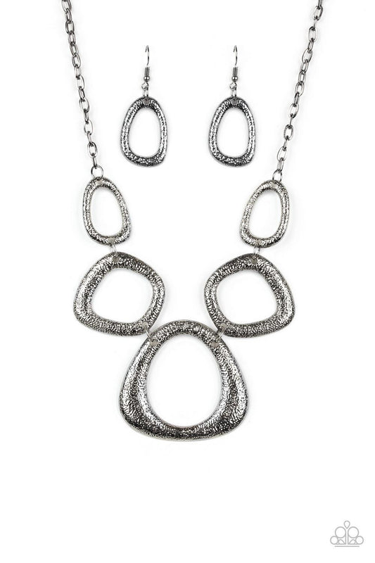 Paparazzi Accessories Backstreet Bandit - Black Hammered in a high-sheen finish, asymmetrical gunmetal frames link below the collar in an edgy statement-making fashion. Features an adjustable clasp closure. Sold as one individual necklace. Includes one pa
