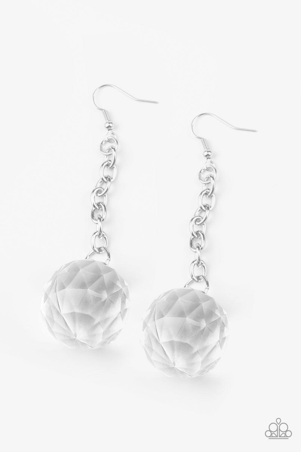 Paparazzi Accessories Spellbound Shimmer - White Featuring a faceted reflection, an exaggerated white gem-like bead dangles from the bottom of a shimmery silver chain for a prismatic look. Earring attaches to a standard fishhook fitting. Jewelry
