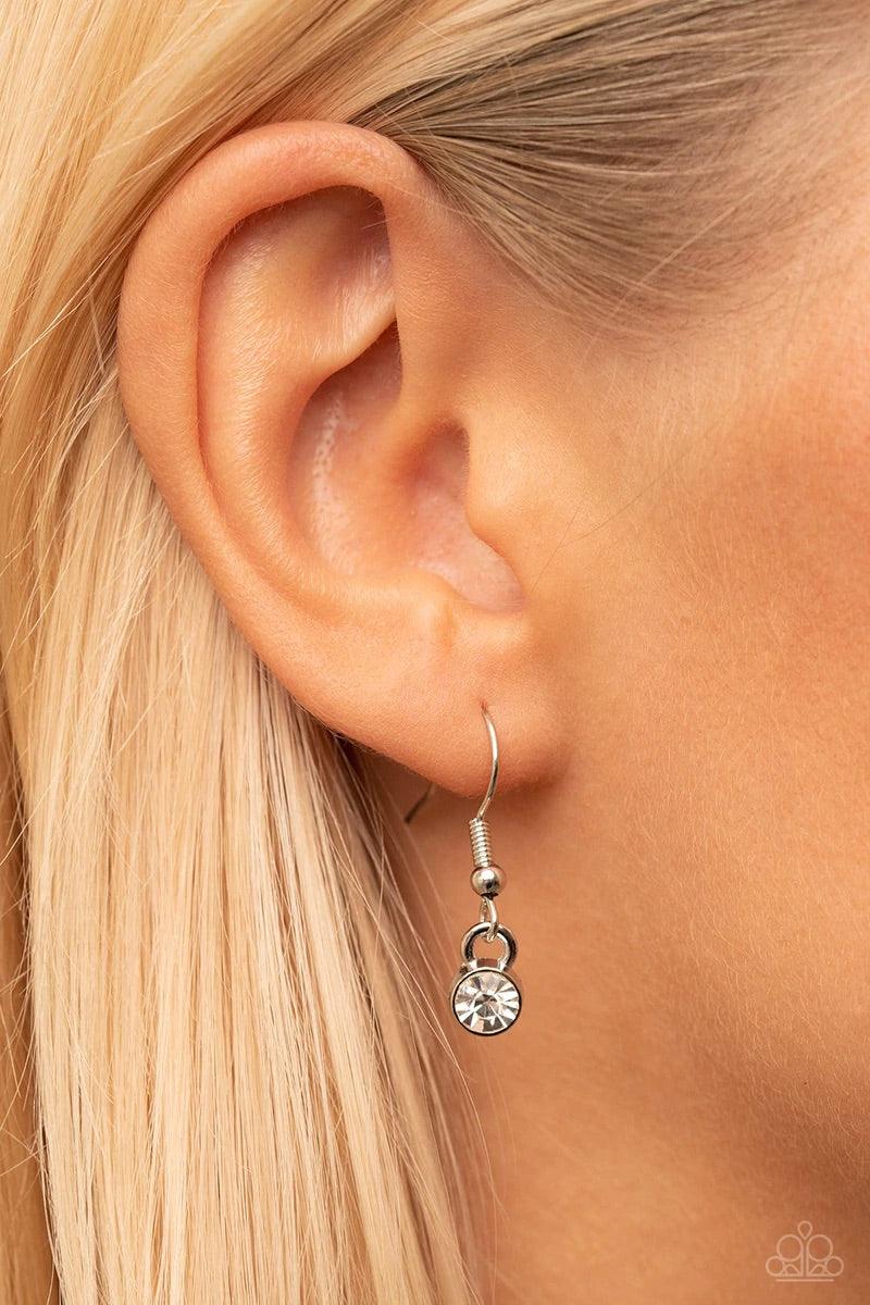 Paparazzi Accessories If You LUST - White A white rhinestone dotted silver heart frame sparkles from a toggle closure at the center of an oval silver linked chain for a flirtatious fashion. Features a toggle closure. Sold as one individual necklace. Inclu