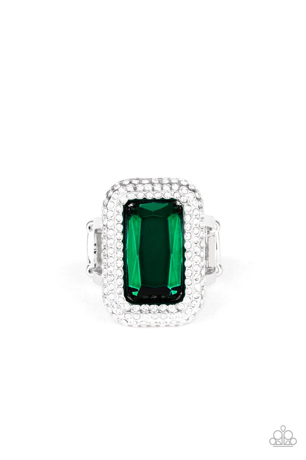 Paparazzi Accessories A Grand STATEMENT-MAKER - Green Featuring a regal emerald style cut, a dramatically oversized green rhinestone is nestled inside a silver frame encrusted in row after row of glassy white rhinestones for a blinding look. Features a st