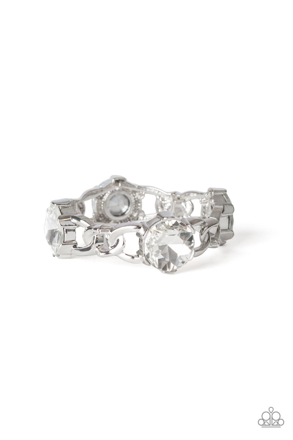 Paparazzi Accessories Light Up The Room - White Featuring glistening silver chain-link fittings, oversized white gem encrusted frames are threaded along a stretchy band around the wrist for a dramatic look. Jewelry